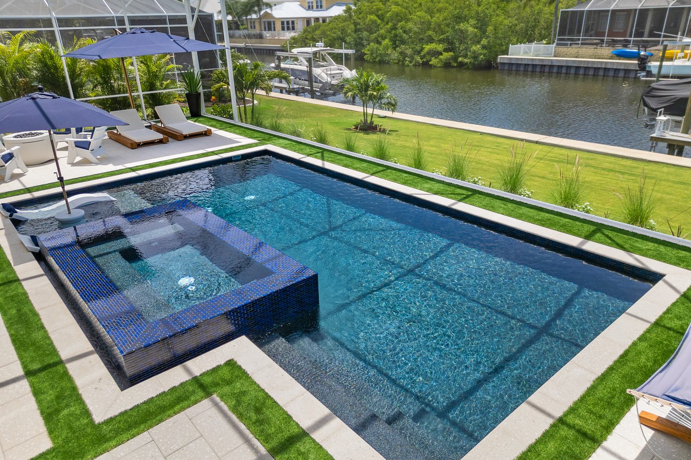 Aerial view of a flagship Pool Perfection freeform custom concrete pool and spa at a waterfront Tampa Bay estate