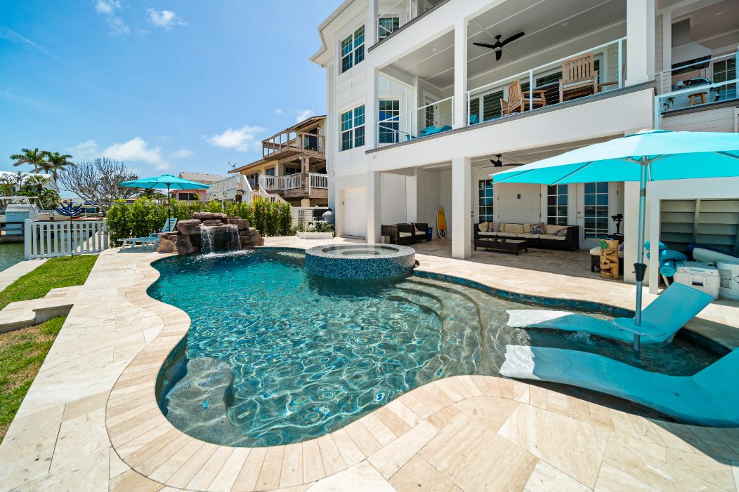 Water-level close-up of custom hand-set glass tile on a Pool Perfection pool